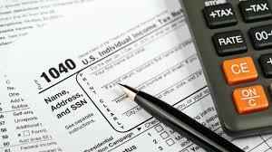 tax form with pen and calculator