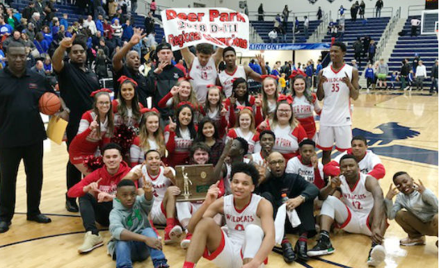 Group picture on basketball court of cheerleaders and basketball team